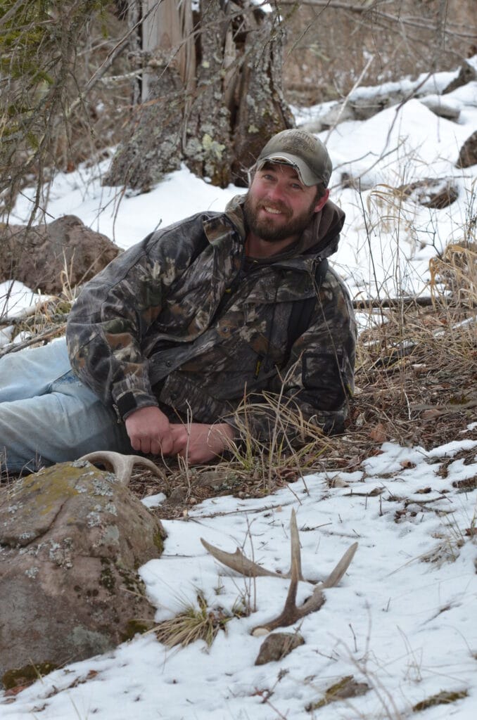 A shed hunter with a shed whitetail antler