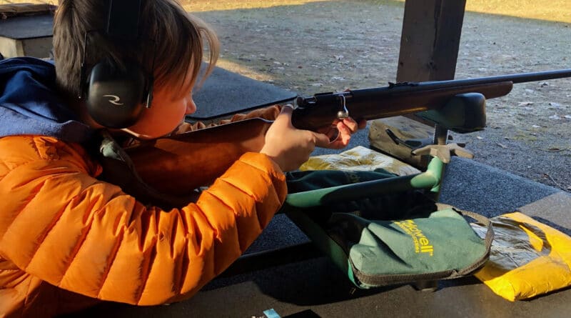 boy shooting a 22 rifle