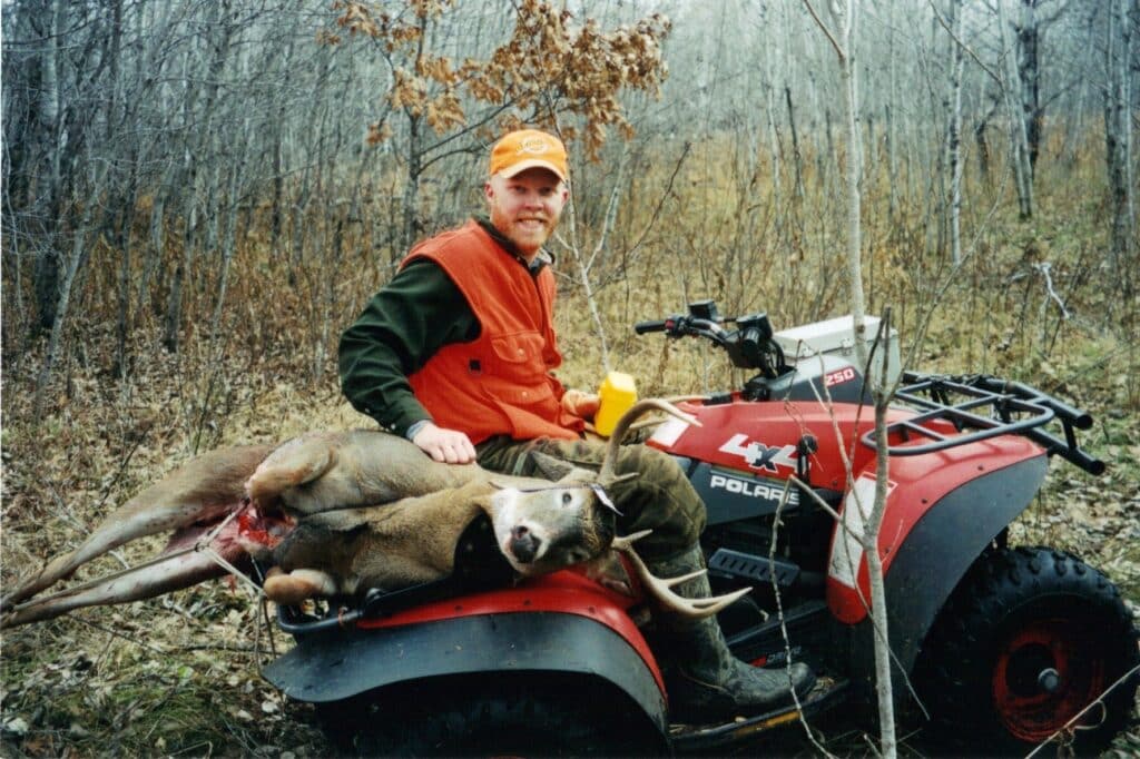 Hunter and deer on a ATV Hunter and deer on a ATV