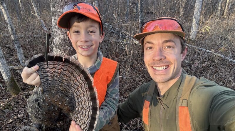 Hunter with son and grouse